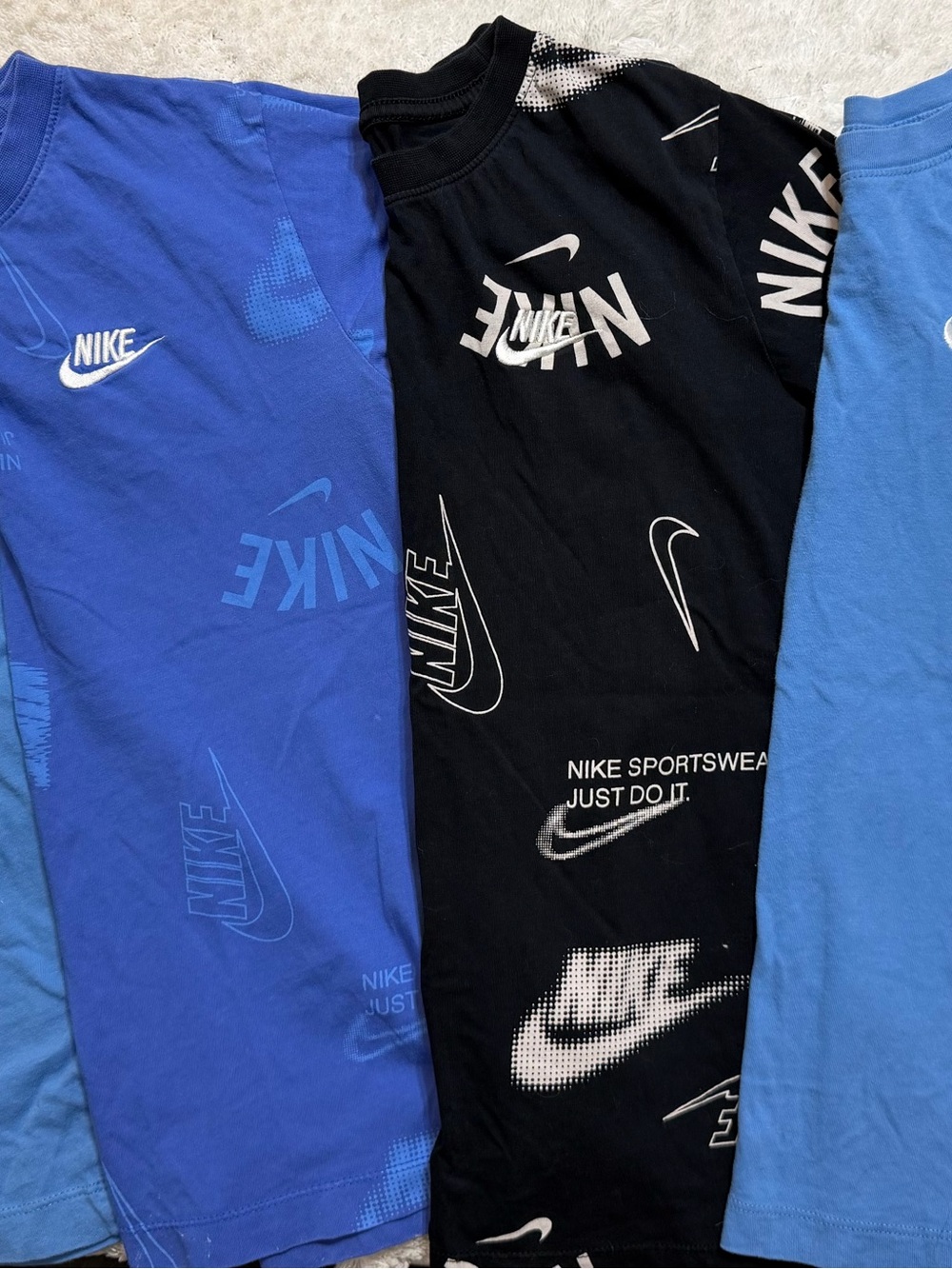 Four Nike Kids' tee shirts